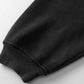 Close-up of a black hoodie sleeve with a ribbed cuff.