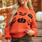Orange round neck sweater with black pumpkin patterns.