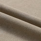 Close-up of beige corduroy fabric with visible ribs and folds.