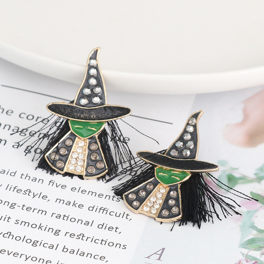 Two witch-shaped alloy earrings with green faces, black hats, and rhinestone details.