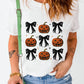 White short-sleeve t-shirt with a pumpkin and bow pattern.