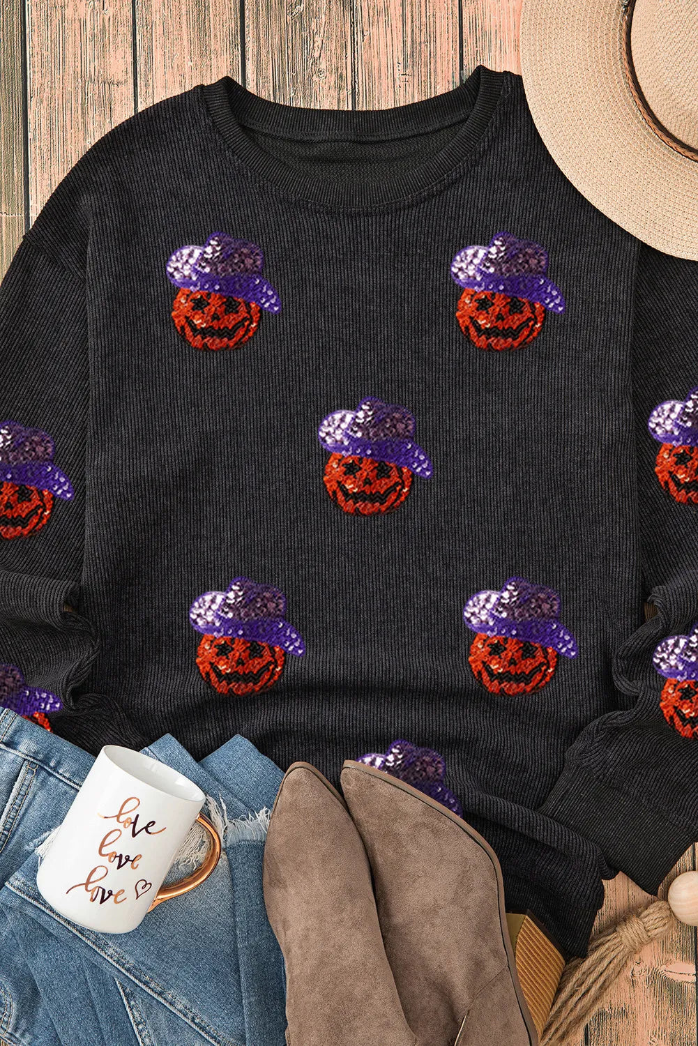 Black long sleeve sweatshirt with sequin pumpkins wearing purple hats.