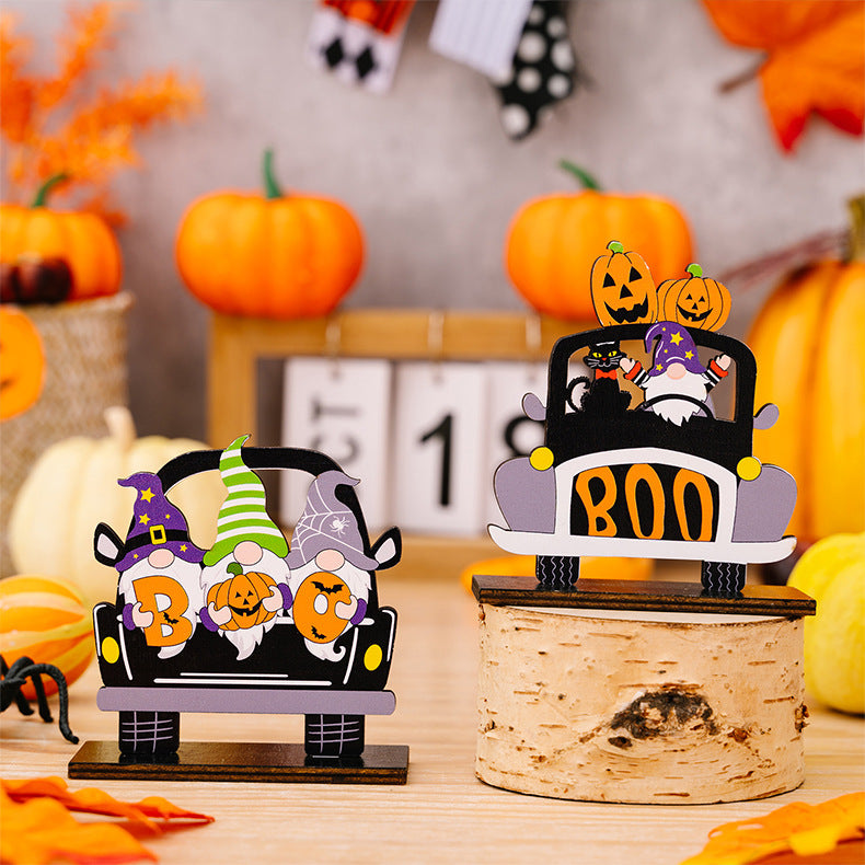Three wooden Halloween car-shaped ornaments featuring gnomes and pumpkins.
