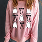 Pink long-sleeve sweatshirt with ghost and bow graphics.