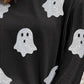 A black long-sleeve top with vertical stripes and glitter ghost designs.