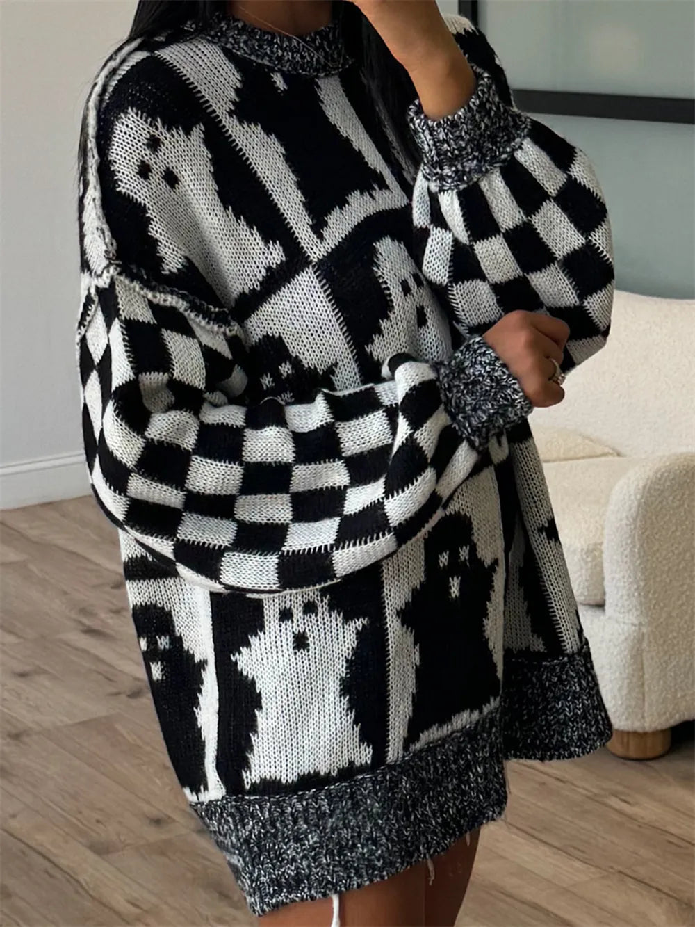 Black and white ghost-patterned dropped shoulder long sleeve sweater.