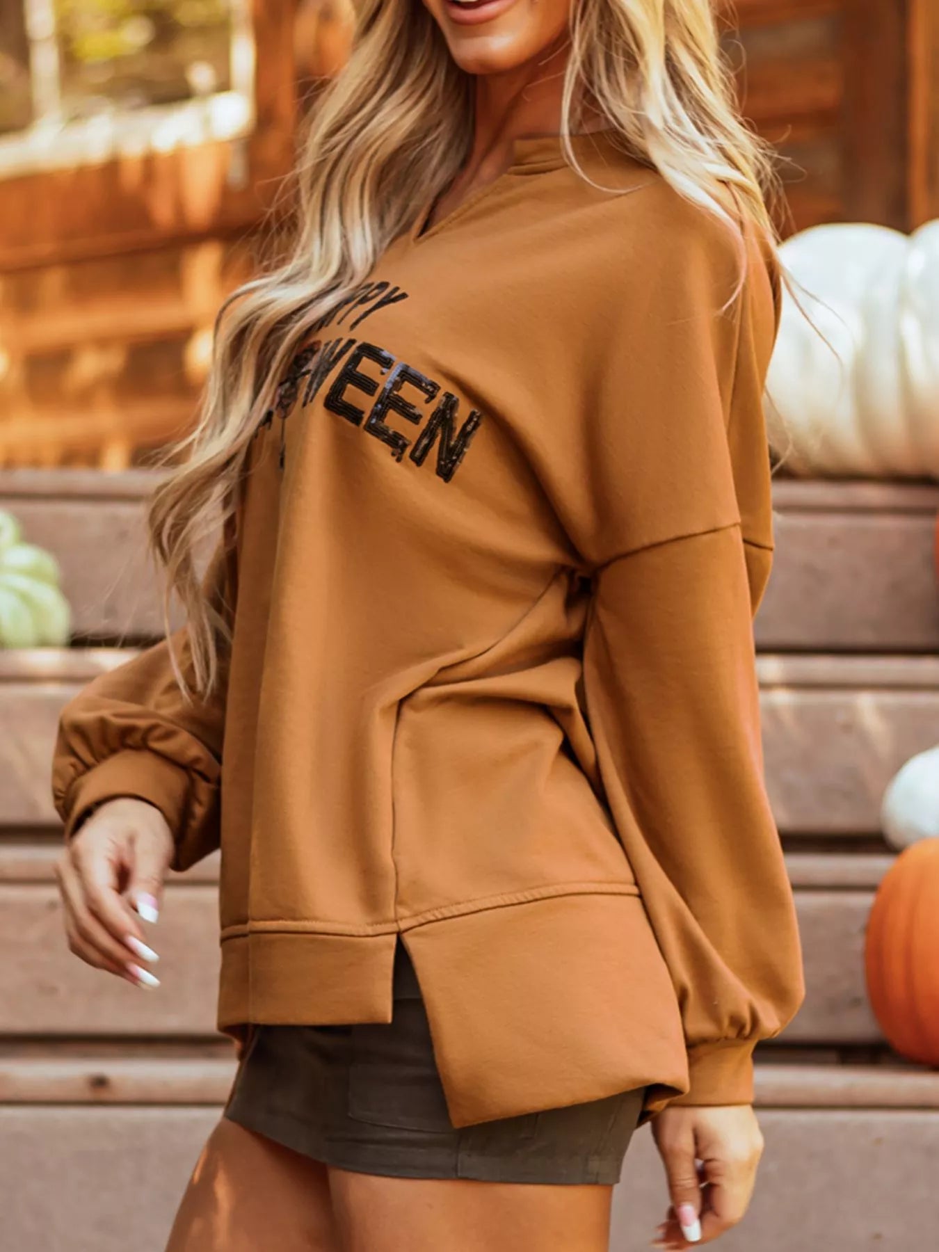 Happy Halloween graphic notched long sleeve loose top in brown.