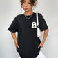 Black short-sleeve t-shirt with a ghost holding coffee graphic.