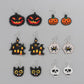 Six pairs of Halloween-themed beaded earrings are displayed on a gray background.