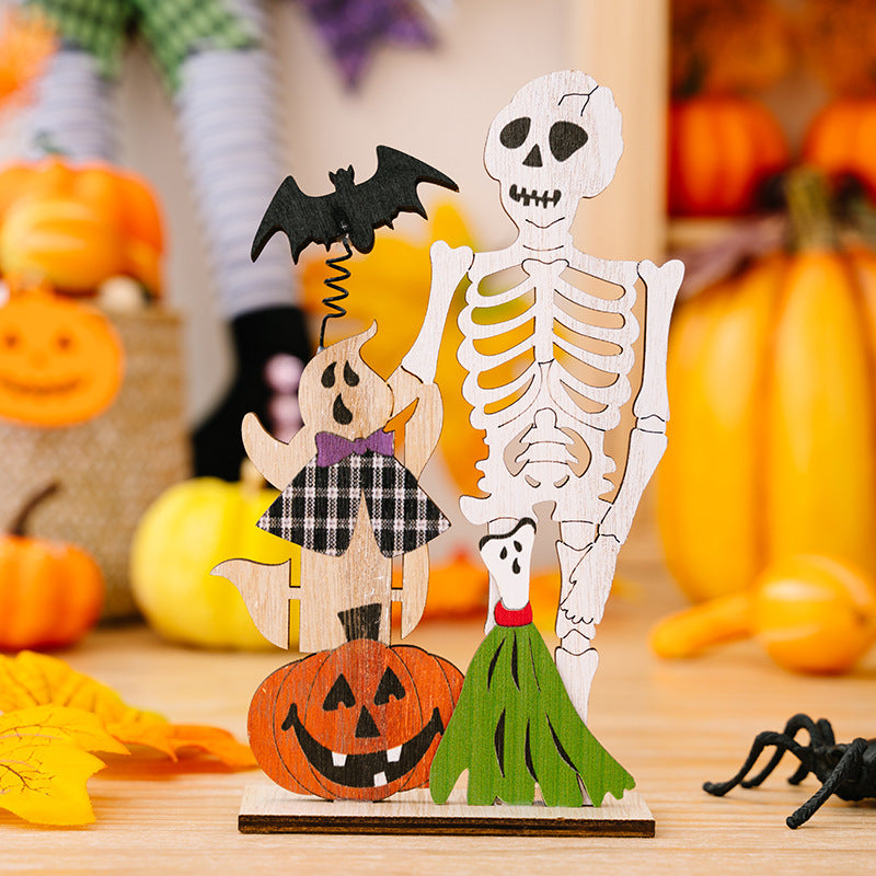 Two wooden Halloween ornaments feature a skeleton, ghost, pumpkin, and broomstick.