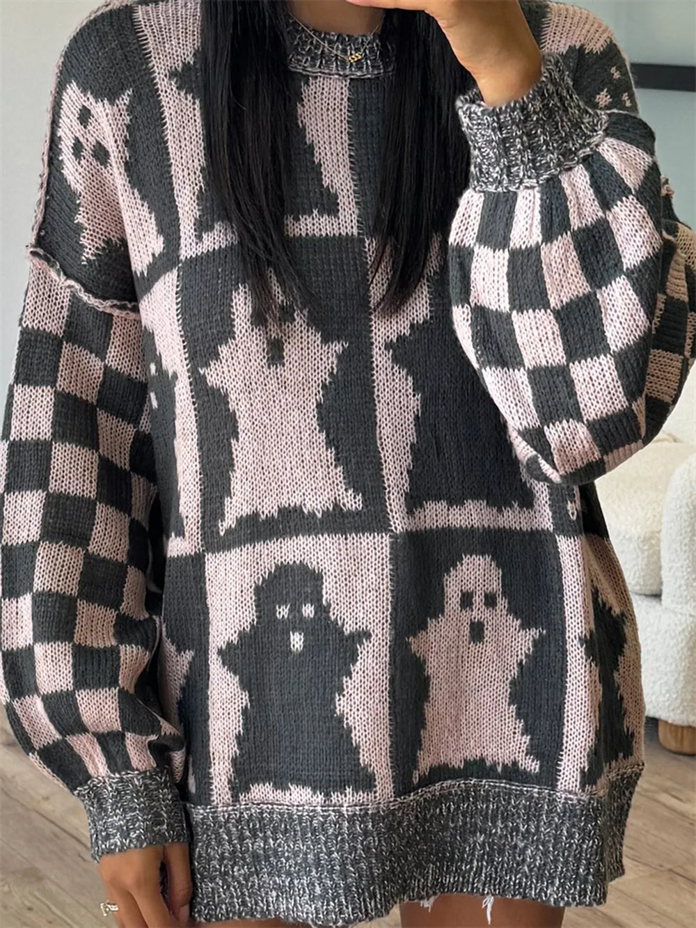 Long sleeve sweater with ghost and checkerboard patterns.