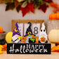 Three Halloween gnome ornaments on a black "Happy Halloween" sign.