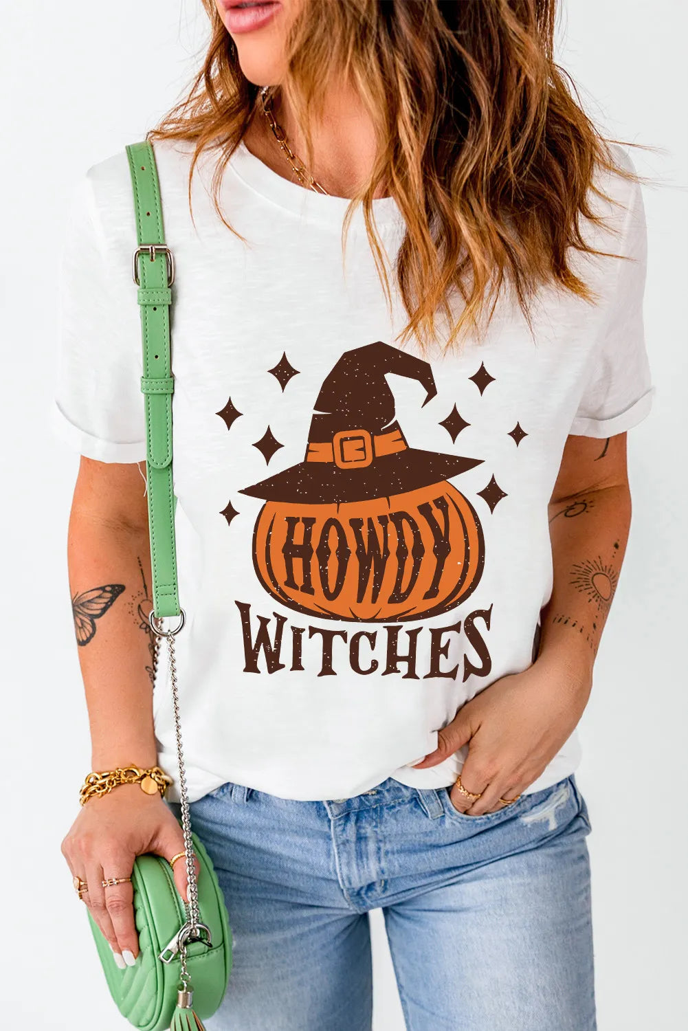 White short-sleeve t-shirt with a "Howdy Witches" pumpkin and witch hat graphic.