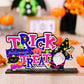 A colorful "Trick or Treat" Halloween sign with a cat and gnome.