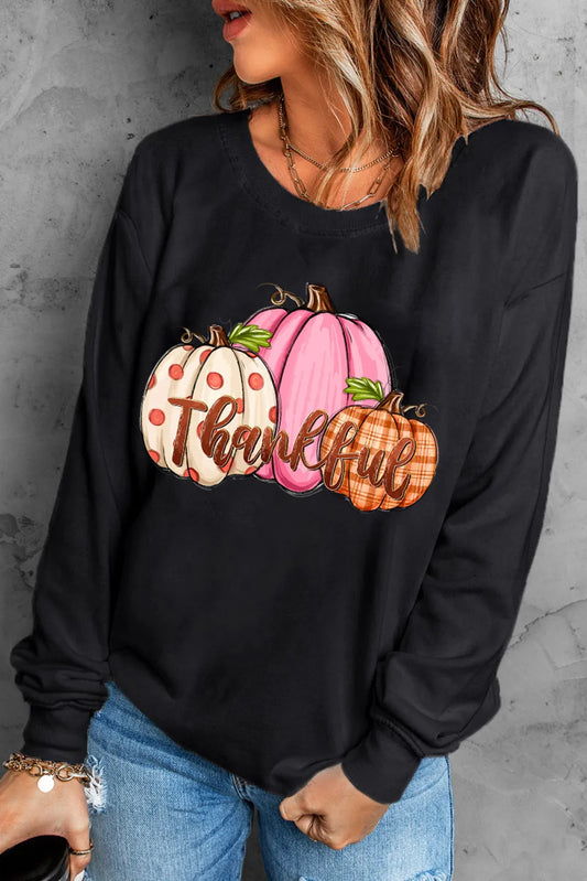 Black round neck dropped shoulder sweatshirt with a pumpkin graphic.
