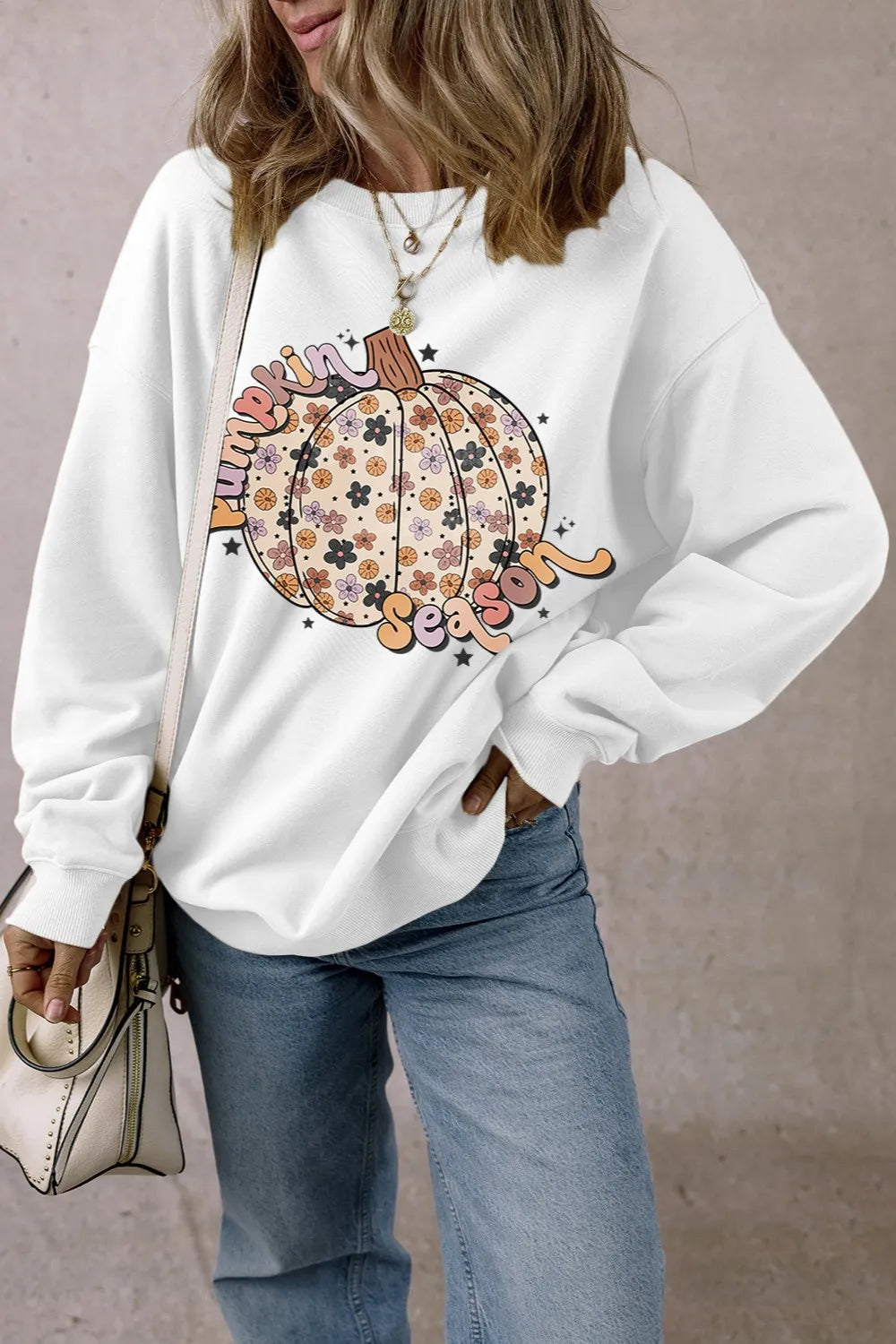 White long-sleeve sweatshirt with a floral pumpkin graphic and "Pumpkin Season" text.