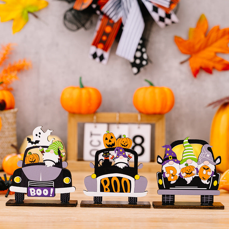 Three wooden Halloween car-shaped ornaments featuring gnomes, pumpkins, and ghosts.