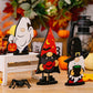Assorted Halloween element ornaments including a ghost, vampire gnome, and witch gnome.