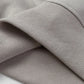 Close-up of a light gray ribbed cuff and hem of a hoodie.