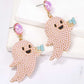 Two pink pearl ghost dangle earrings with black faces and blue accents.