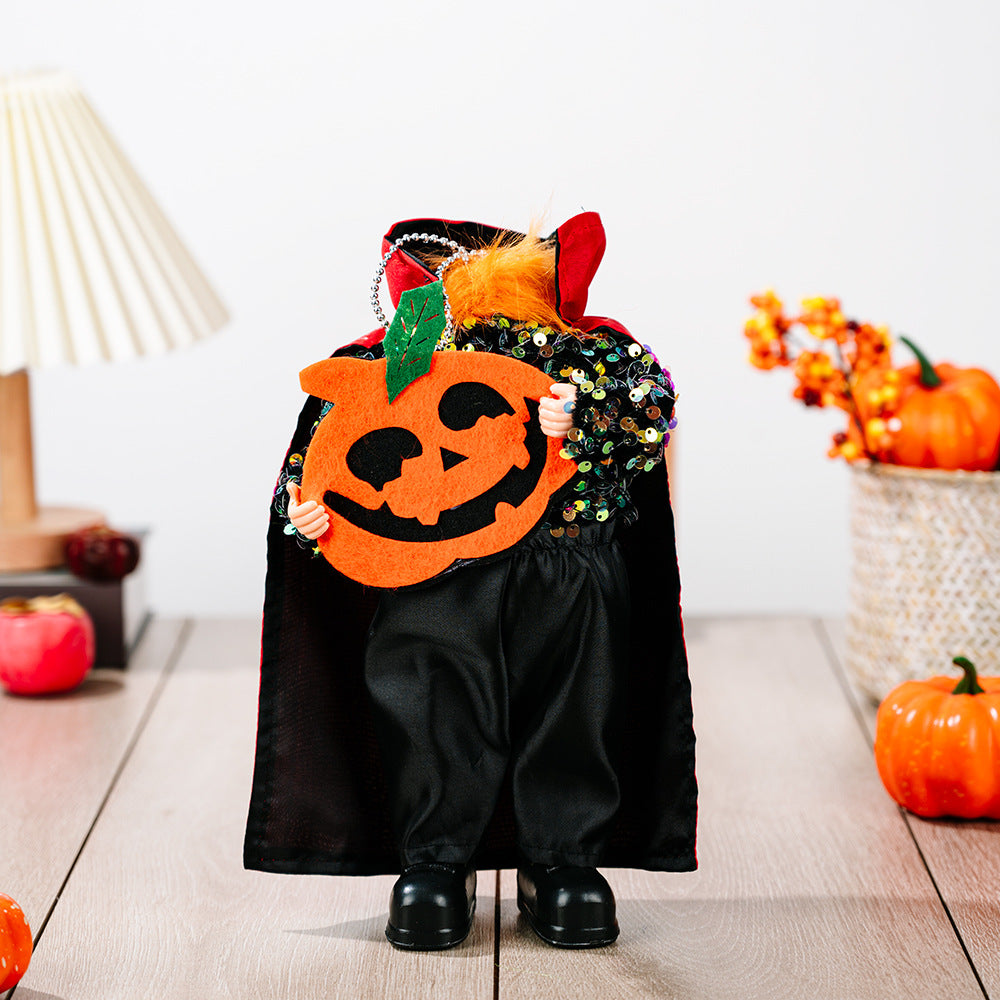 A Halloween hanging widget with a sequined top, black cape, and a pumpkin cutout.