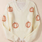 Raw hem pumpkin V-neck long sleeve sweater.