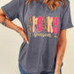A woman wears a gray "Spooky Season" graphic t-shirt with leopard print and pink letters.