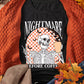 Black tee with a skeleton holding coffee and "NIGHTMARE BEFORE COFFEE" text.
