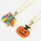 Two Halloween-themed necklaces, one with "Trick or Treat" and one with a jack-o'-lantern.