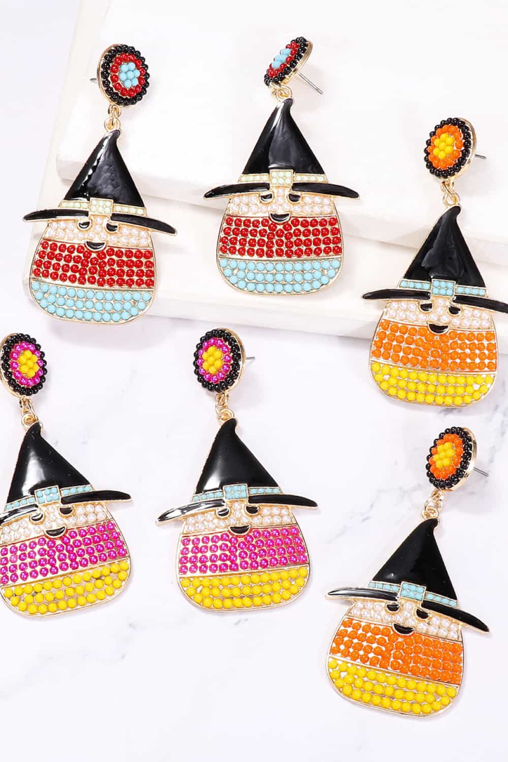 Six pairs of witch's hat-shaped dangle earrings with colorful synthetic pearls.