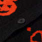 Black button-up cardigan with orange Halloween pumpkin patterns.