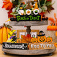 Assorted Halloween element ornaments displayed on a two-tiered wooden tray.
