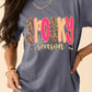 A woman wears a gray "Spooky Season" graphic t-shirt with leopard print letters.