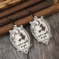 A pair of witch-themed wooden dangle earrings with the phrase "I put a spell on you."