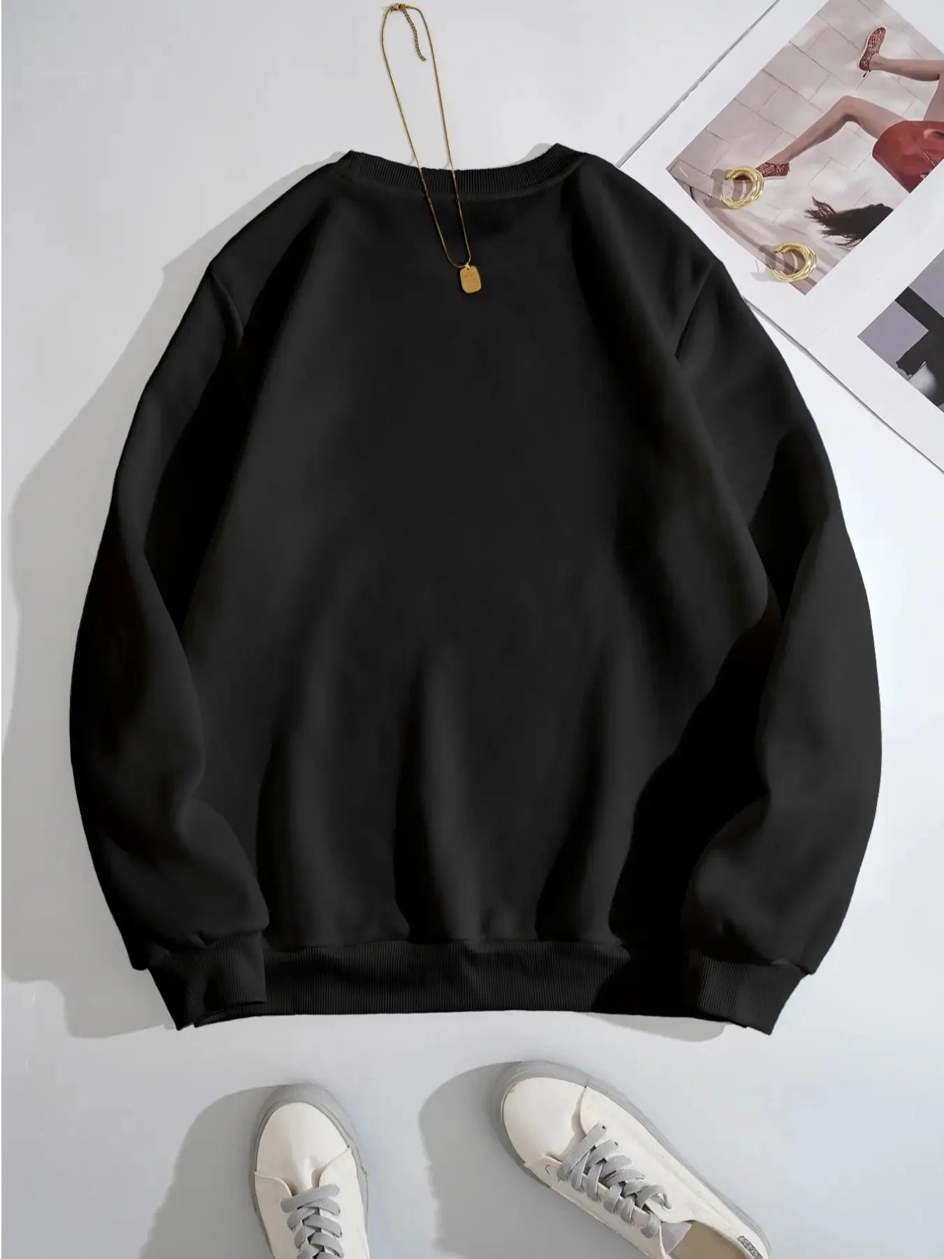 Black long-sleeve sweatshirt with a ribbed crew neck and cuffs.