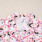A pink Halloween ghost print button-up top with a collar and pink piping.