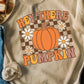 A beige long-sleeve sweatshirt with a "Hey There Pumpkin" graphic and checkered background.