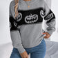 Gray long-sleeve sweater with black and white pumpkin pattern.