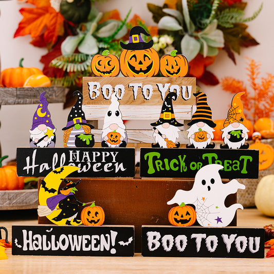 Assorted Halloween ornaments featuring gnomes, pumpkins, and ghosts on wooden blocks.