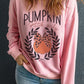 A woman wears a pink "Pumpkin Patch Girly" sweatshirt with a pumpkin graphic.