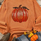 Orange ribbed long-sleeve sweatshirt with a sequin pumpkin design.