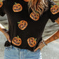 Black short-sleeve t-shirt with sequin pumpkin designs.