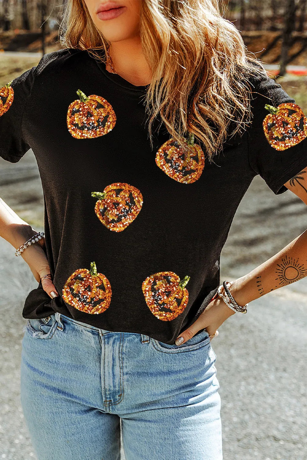 Black short-sleeve t-shirt with sequin pumpkin designs.