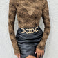 A woman wears a sheer, long-sleeve blouse with a black spider web print.
