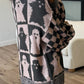 Ghost dropped shoulder long sleeve sweater with a checkered sleeve.