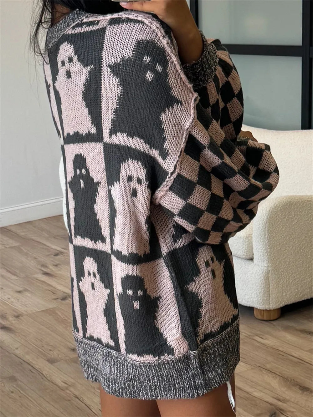 Ghost dropped shoulder long sleeve sweater with a checkered sleeve.