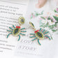 Spider rhinestone alloy earrings with green, blue, and red accents.