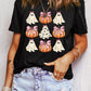 Black t-shirt with a Halloween graphic of ghosts and pumpkins with pink bows.