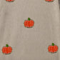 A beige long-sleeve sweatshirt with embroidered orange pumpkins.