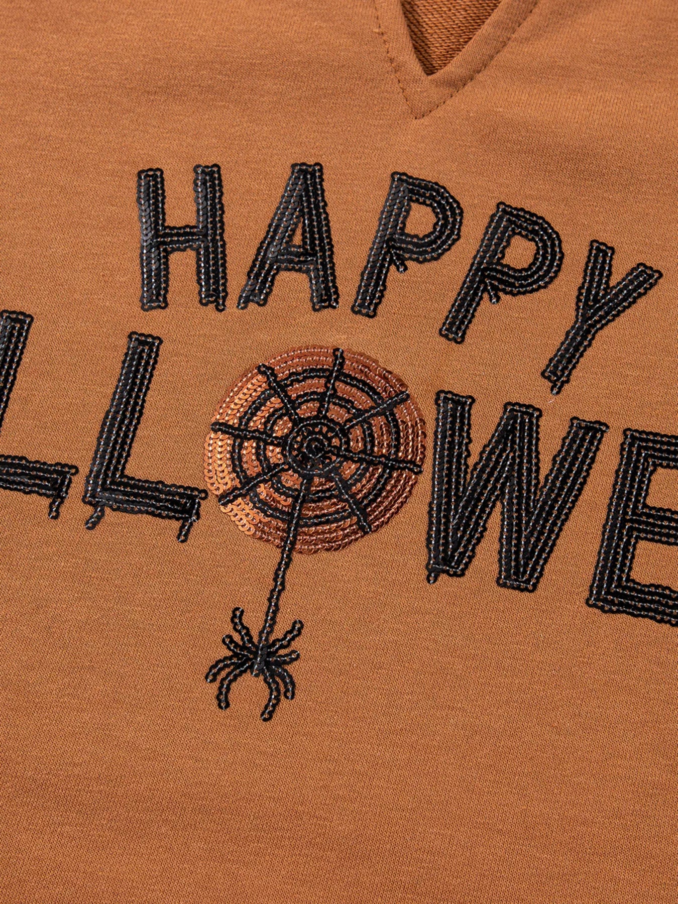 Happy Halloween graphic notched long sleeve loose top with a spiderweb and spider.